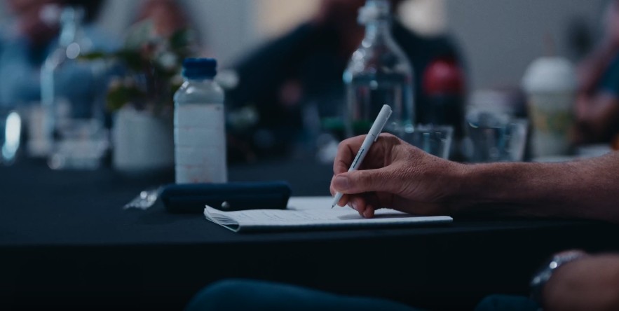A member taking notes during a session